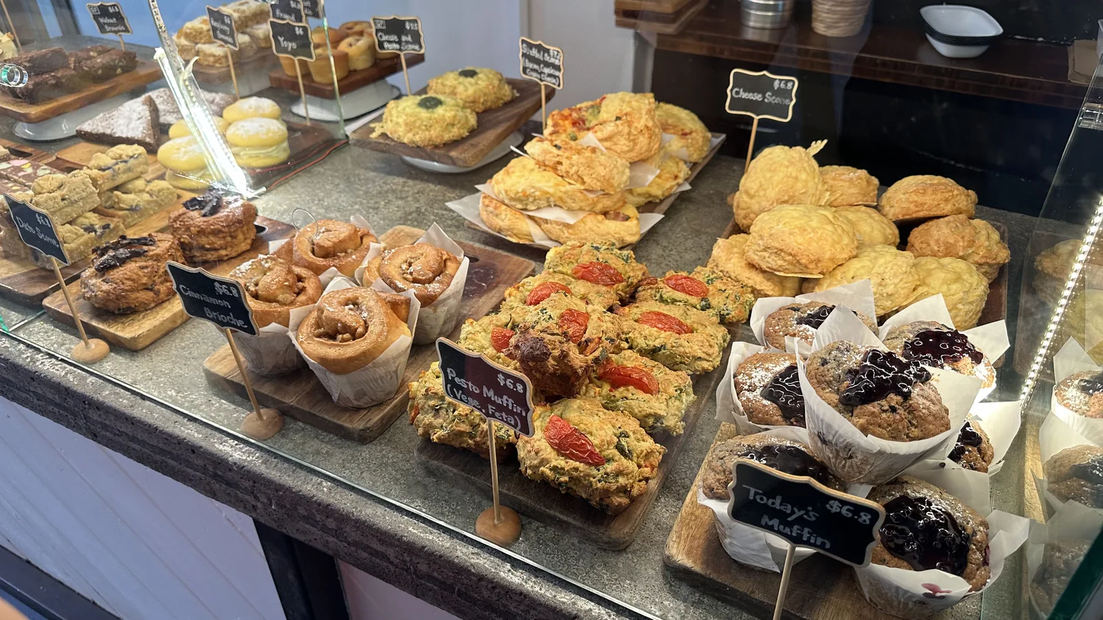 The food cabinet filled with baked and savoury cafe choices