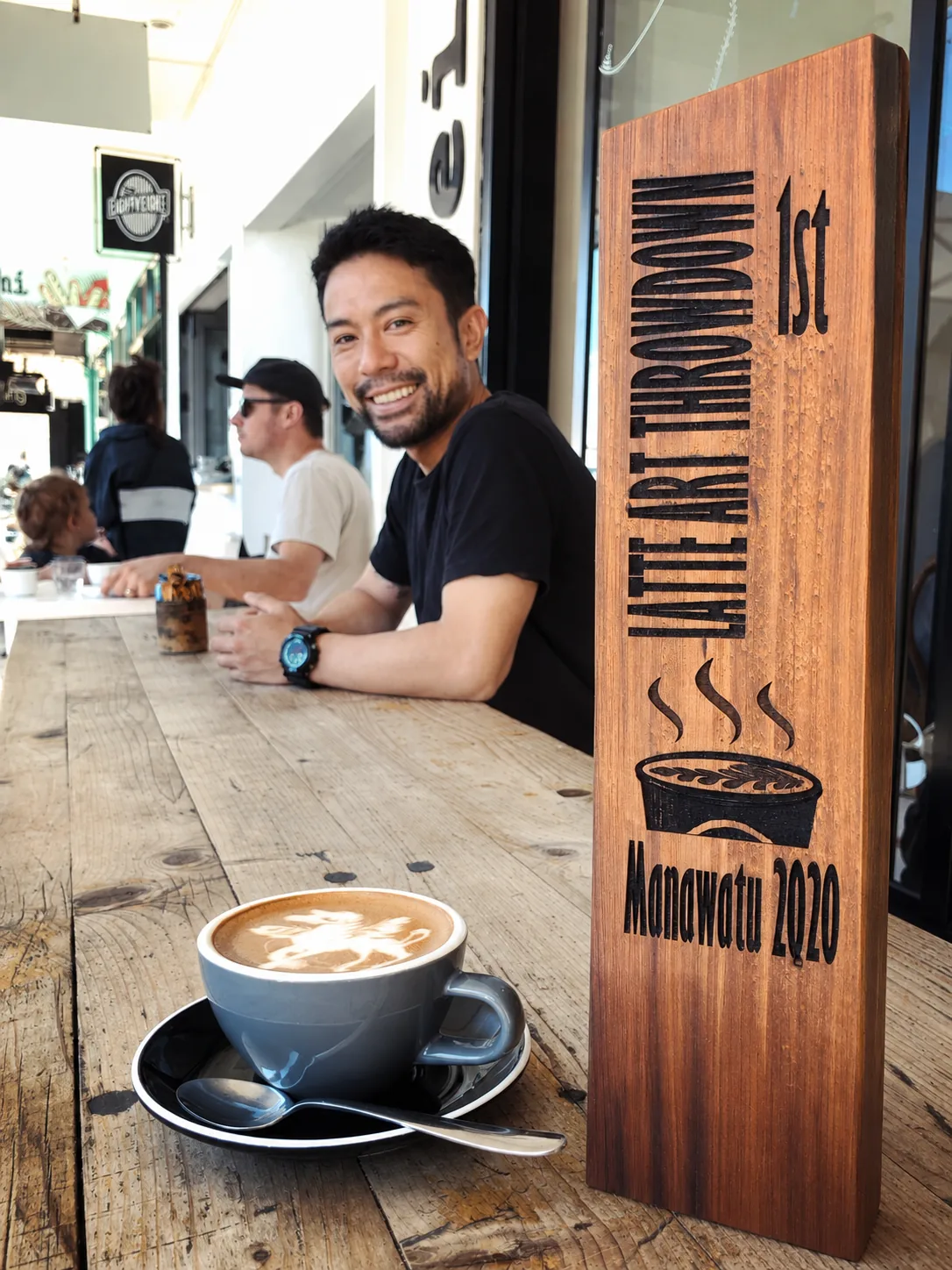 A flat white beside the eightyeight Cafe counter sign